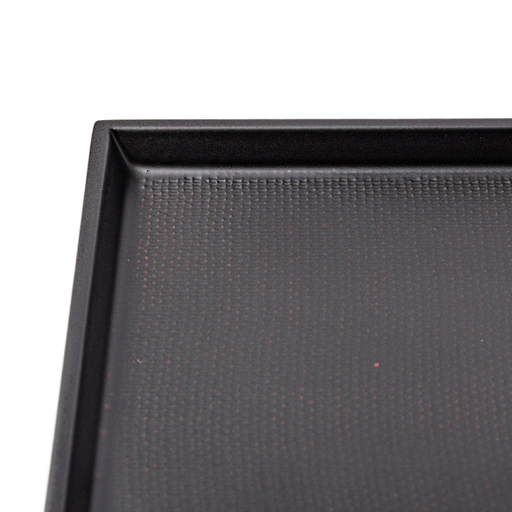 Modern Japanese black lacquer serving tray with horizontal grain texture and side grooves for easy use.