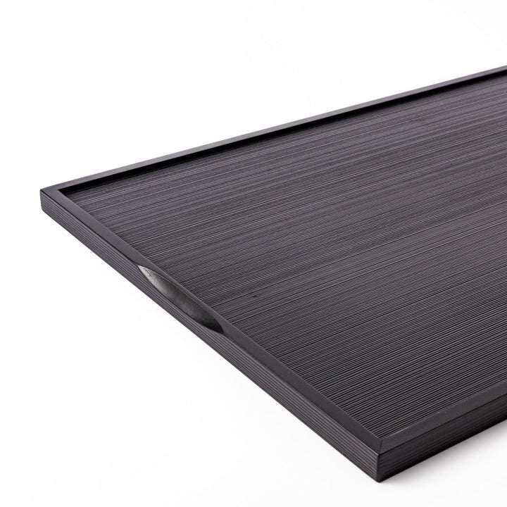Modern Japanese black lacquer serving tray with horizontal grain texture and side grooves for easy use.
