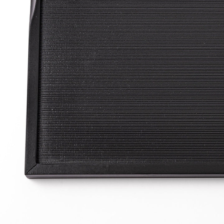 Modern Japanese black lacquer serving tray with horizontal grain texture and side grooves for easy use.