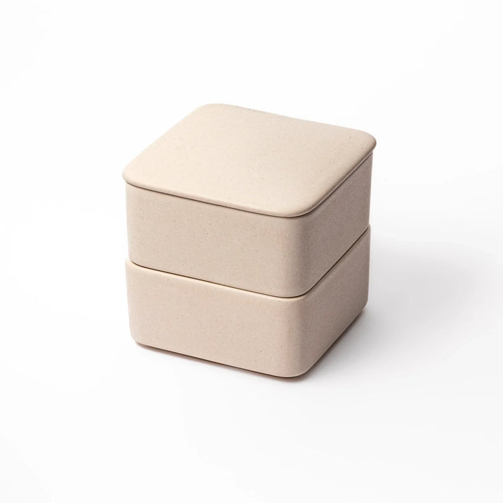 Minimalist white Japanese porcelain bento box set, two-tiered design for elegant meal presentation and versatile storage.