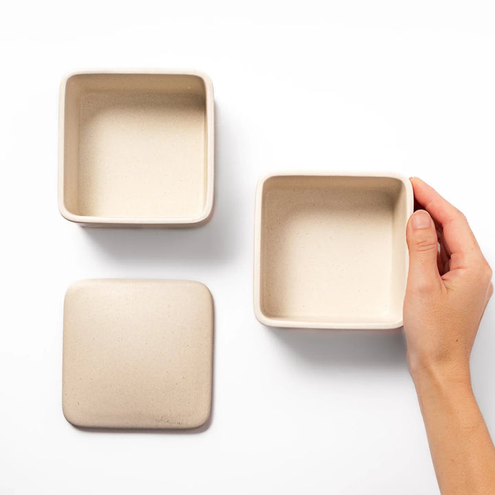 Minimalist white Japanese porcelain bento box set, two-tiered design for elegant meal presentation and versatile storage.