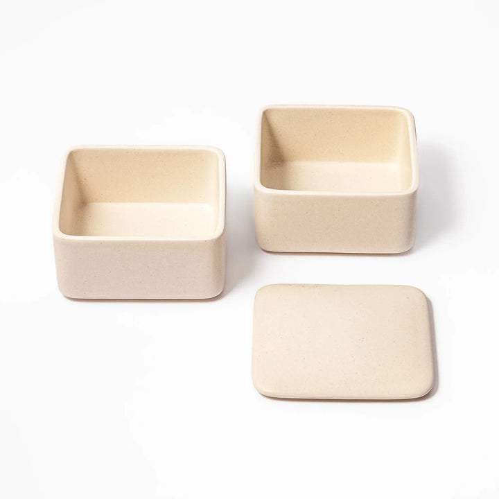Minimalist white Japanese porcelain bento box set, two-tiered design for elegant meal presentation and versatile storage.