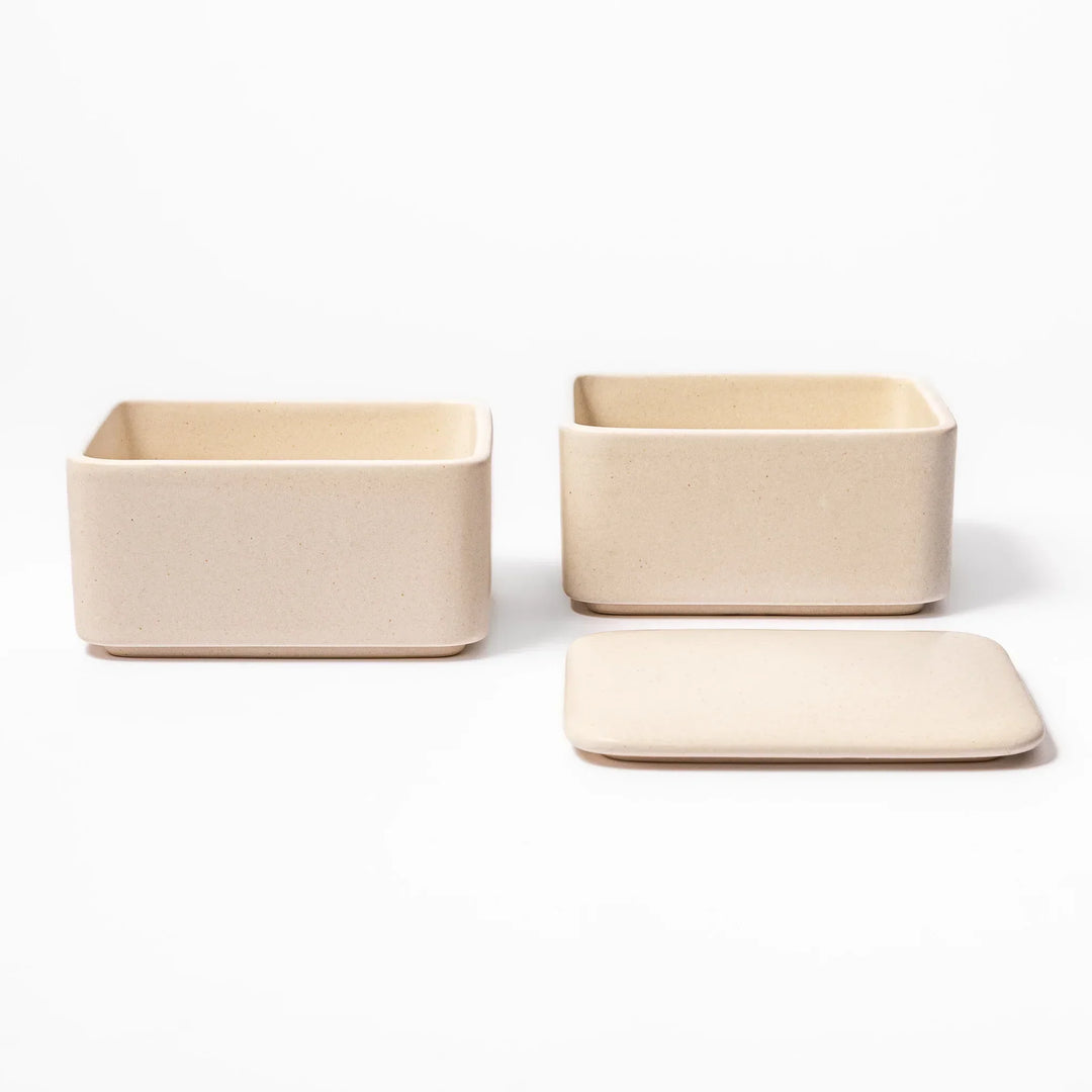 Minimalist white Japanese porcelain bento box set, two-tiered design for elegant meal presentation and versatile storage.