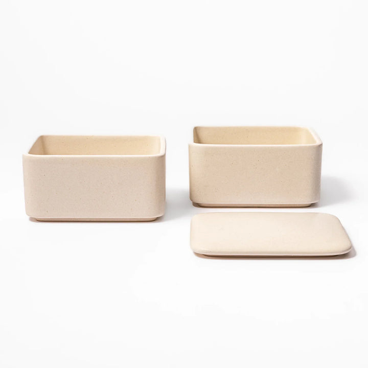 Minimalist white Japanese porcelain bento box set, two-tiered design for elegant meal presentation and versatile storage.