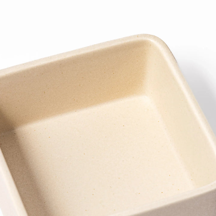 Minimalist white Japanese porcelain bento box set, two-tiered design for elegant meal presentation and versatile storage.