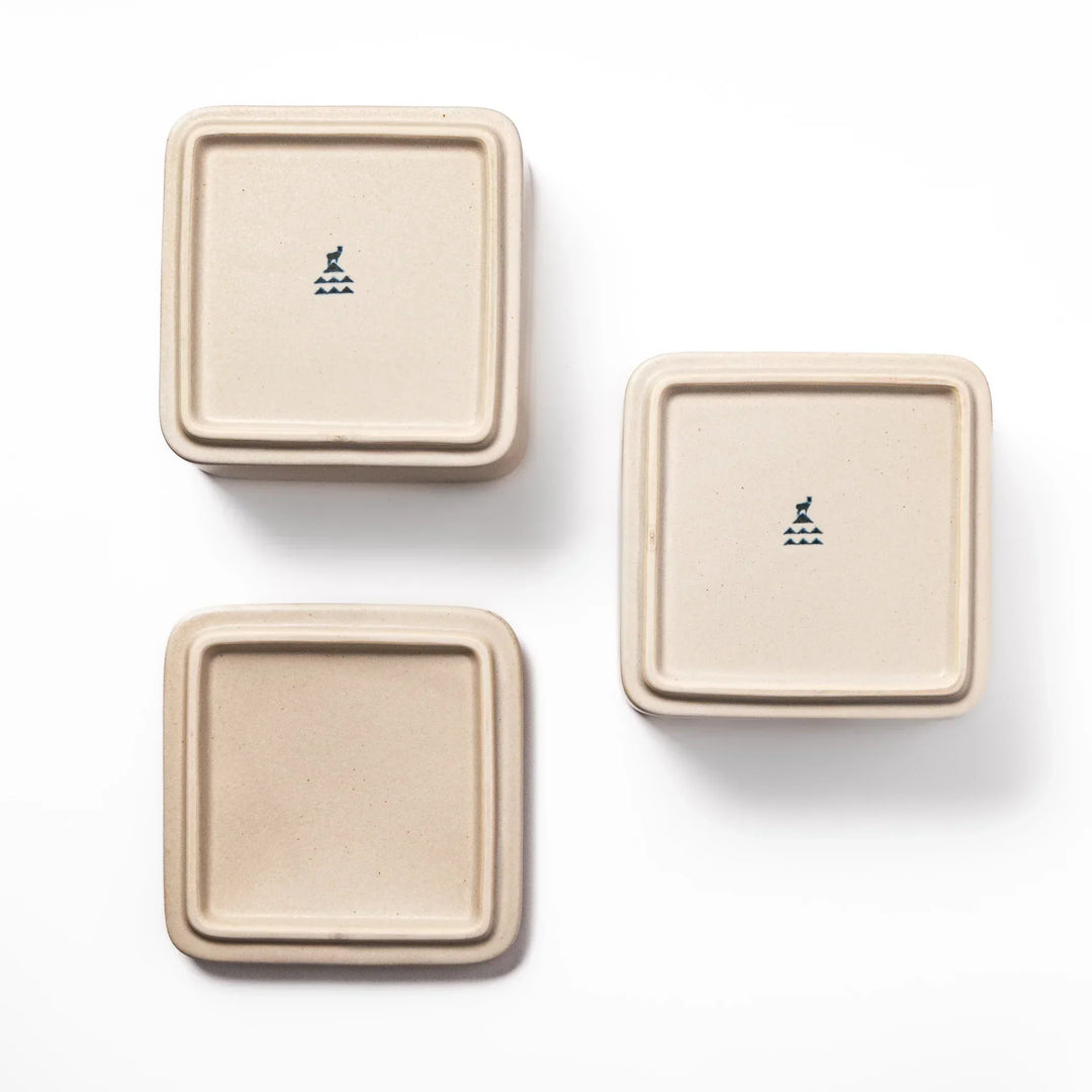 Minimalist white Japanese porcelain bento box set, two-tiered design for elegant meal presentation and versatile storage.