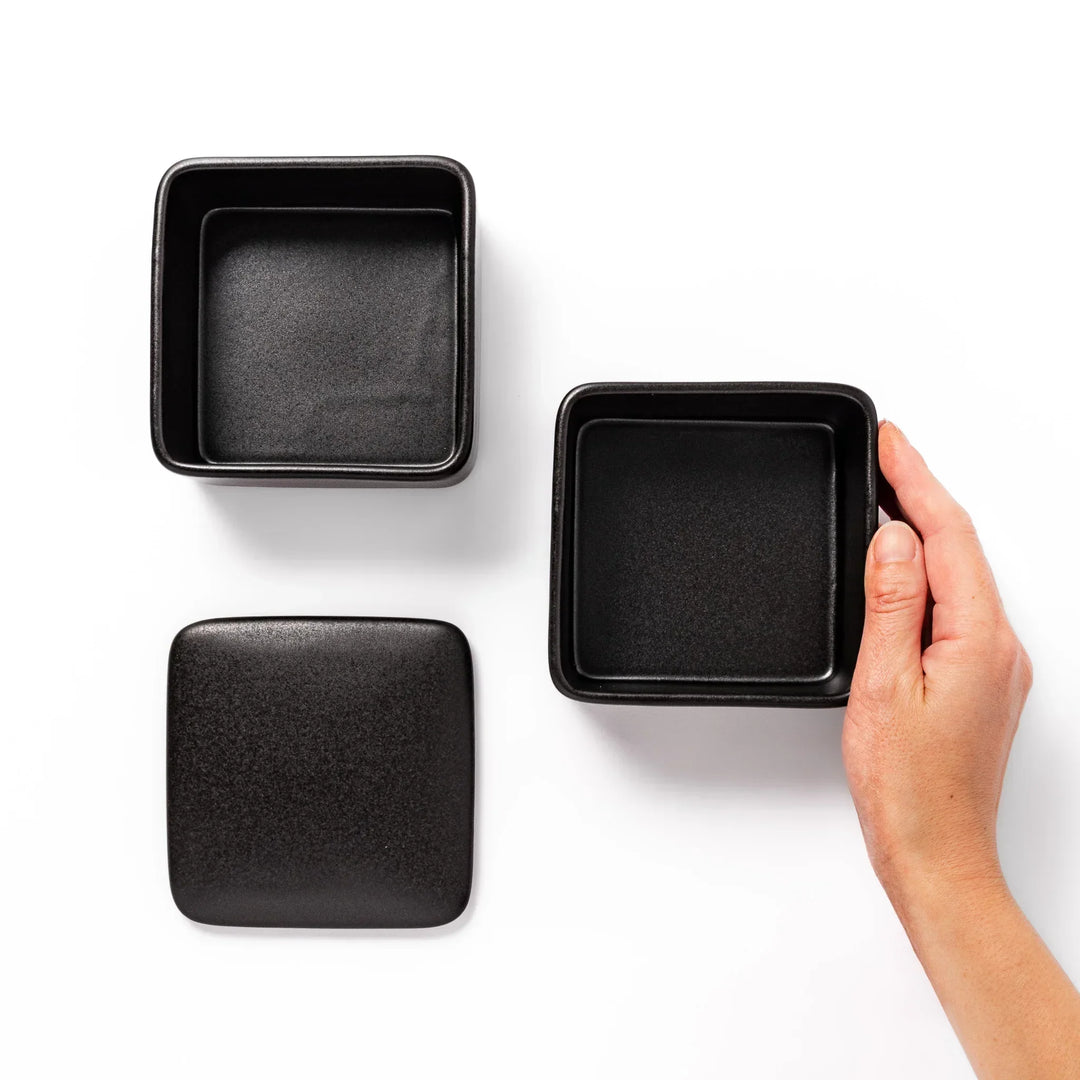 Sleek black Japanese porcelain two tier bento box set with minimalist design for modern meal presentation.