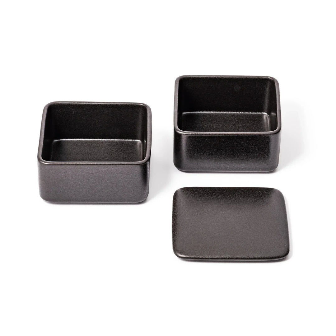 Sleek black Japanese porcelain two tier bento box set with minimalist design for modern meal presentation.