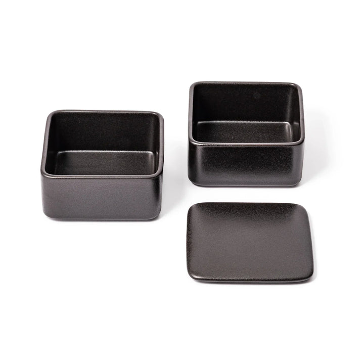 Sleek black Japanese porcelain two tier bento box set with minimalist design for modern meal presentation.