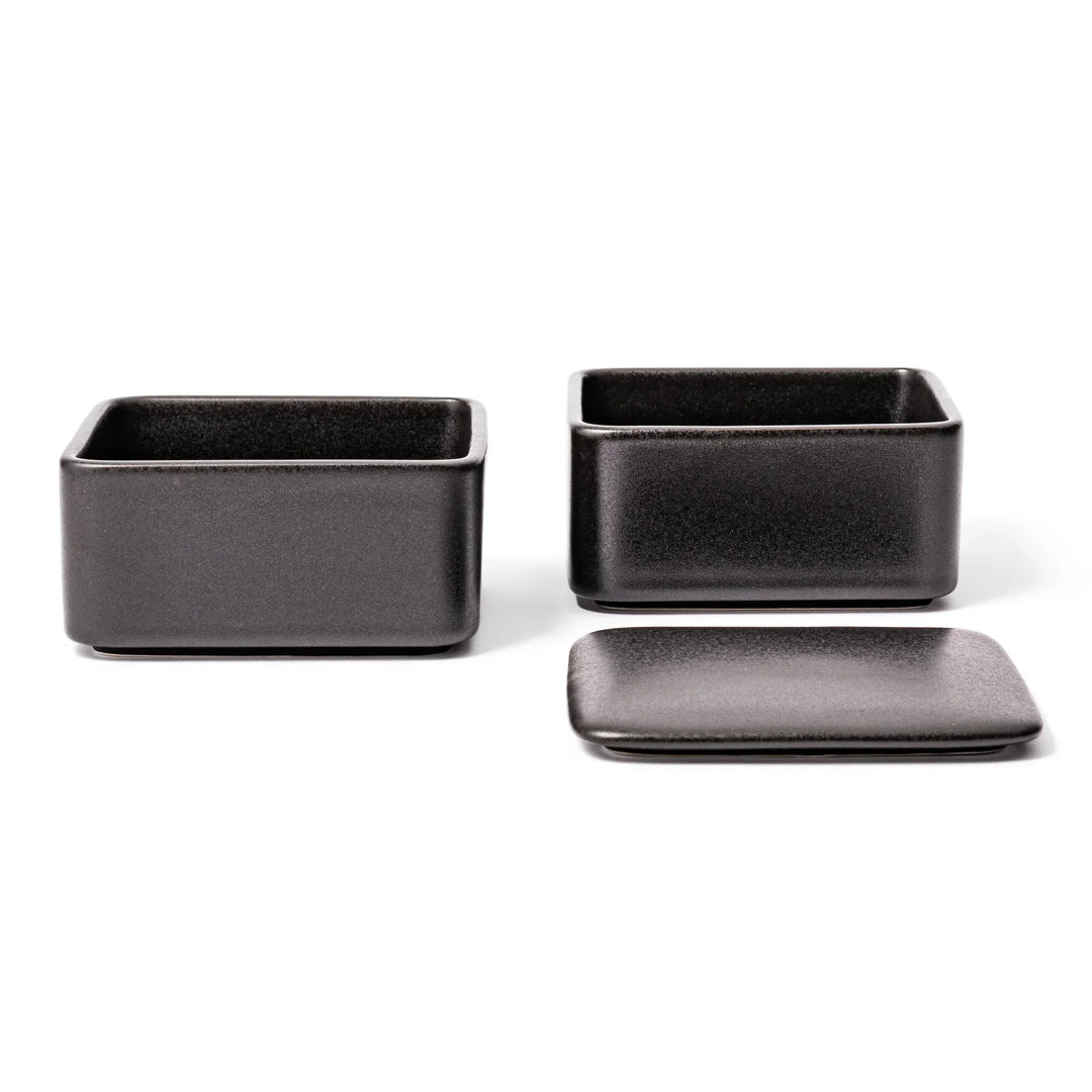 Sleek black Japanese porcelain two tier bento box set with minimalist design for modern meal presentation.