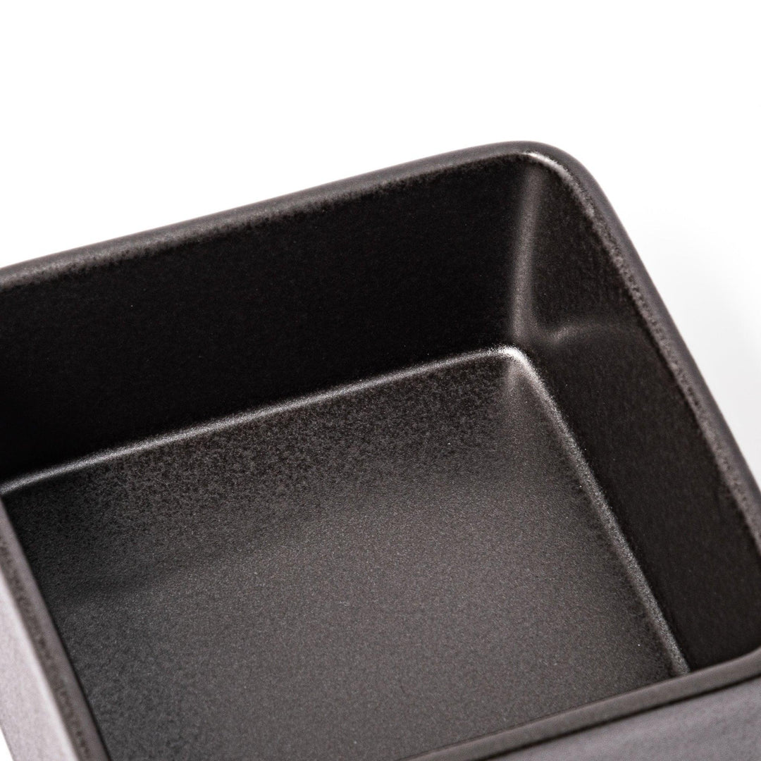 Sleek black Japanese porcelain two tier bento box set with minimalist design for modern meal presentation.