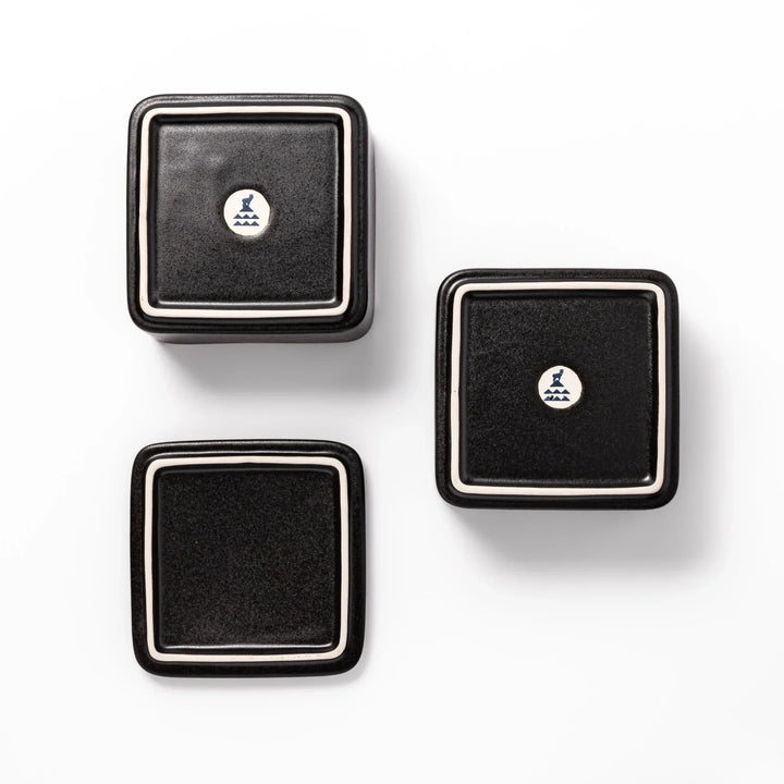 Sleek black Japanese porcelain two tier bento box set with minimalist design for modern meal presentation.