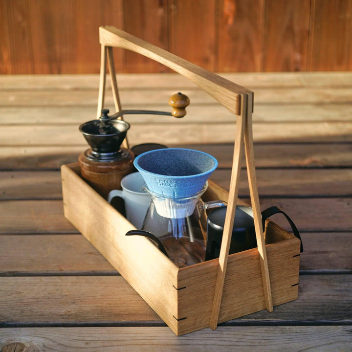 Japanese wooden okamochi storage caddy holding coffee dripper carafe manual grinder and cup on wooden table