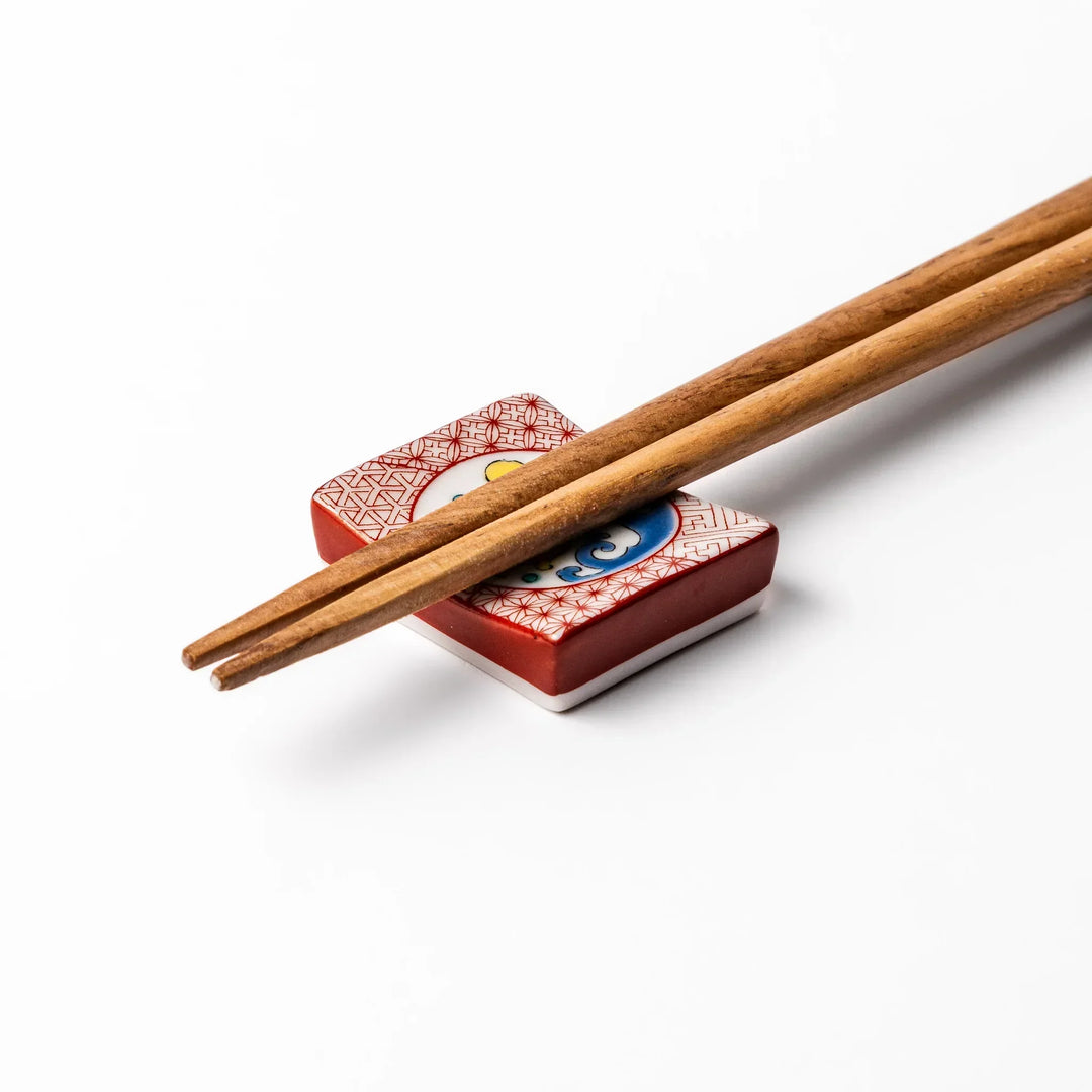 Rectangular Japanese ceramic chopstick rest with red geometric pattern and moon rabbit motif for charm.