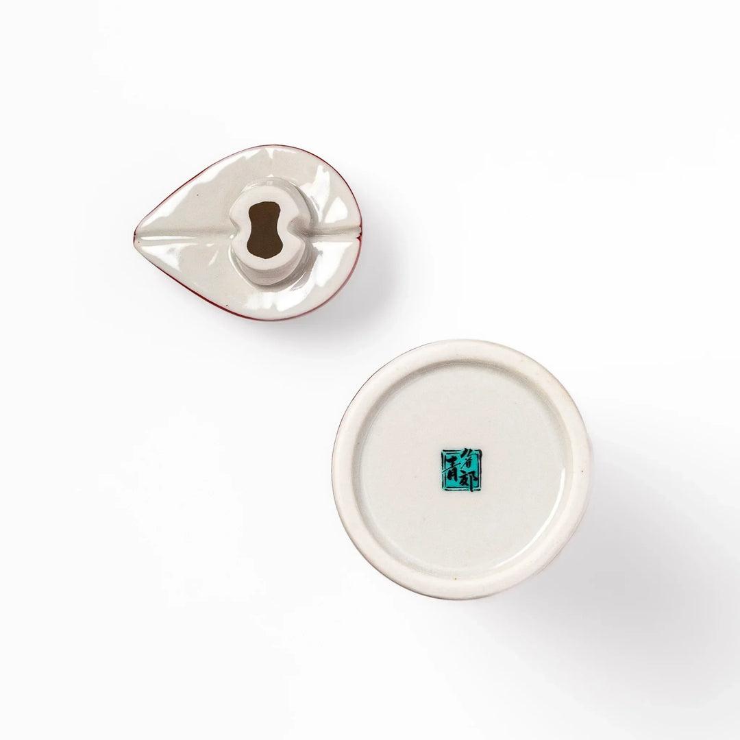 Japanese ceramic soy sauce dispenser with red geometric pattern and moon rabbit motif for elegant dining.