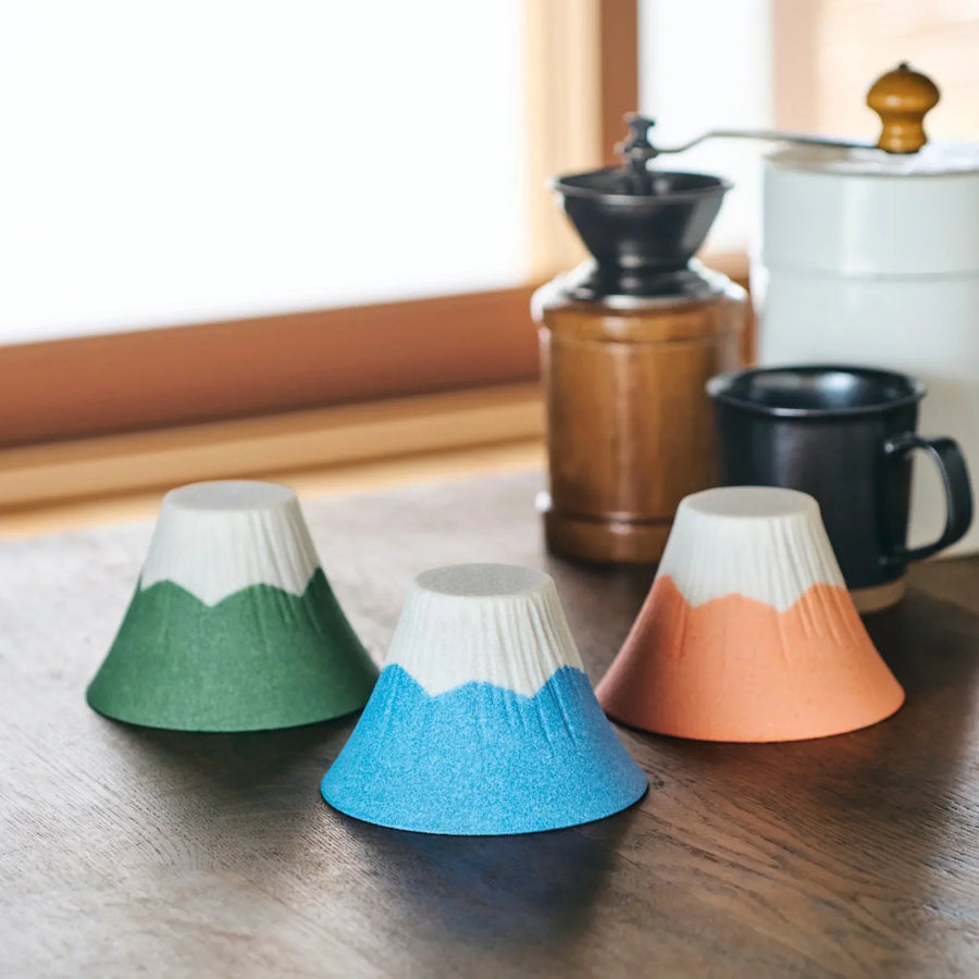 Handcrafted Mount Fuji ceramic coffee filter in green blue and orange adding Japanese charm to brewing.