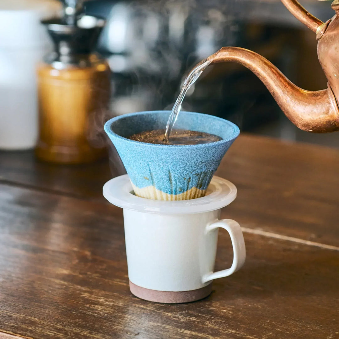 Handcrafted Mount Fuji ceramic coffee filter in green blue and orange adding Japanese charm to brewing.