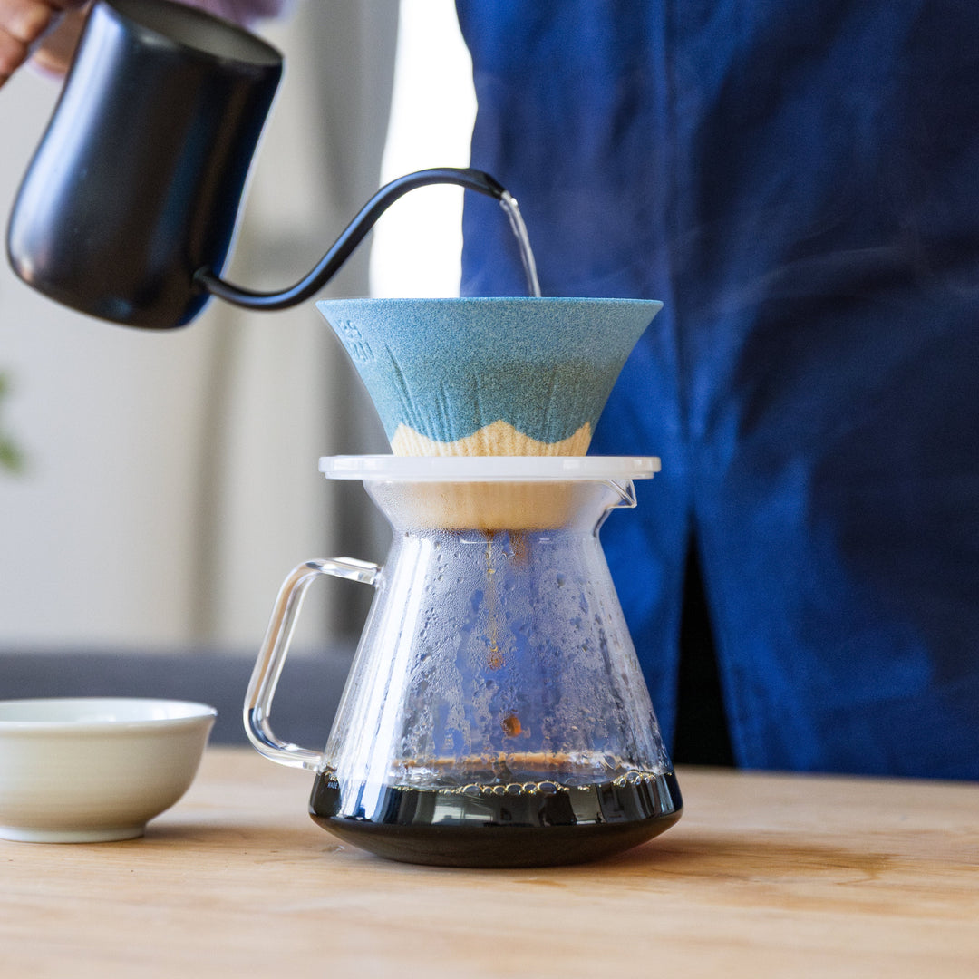Nami from Just One Cookbook brewing pour over coffee with Mount Fuji ceramic coffee filter over glass server