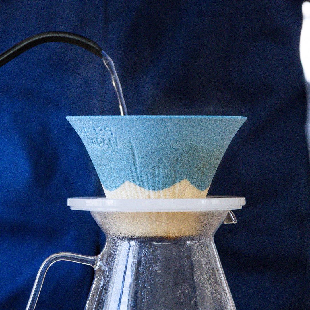 Hot water pouring through Mount Fuji ceramic coffee filter during pour over brewing