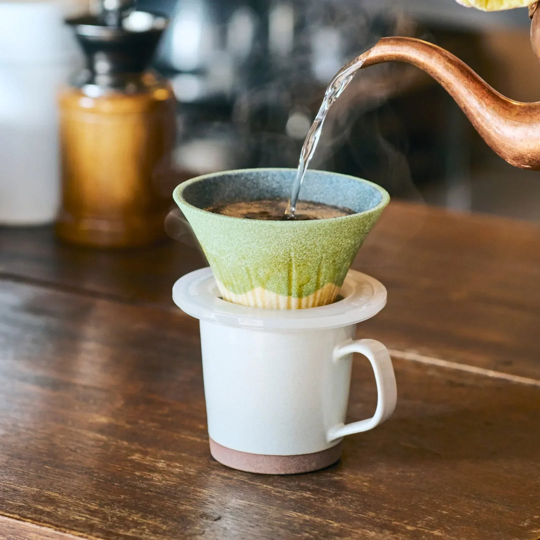 Handcrafted Mount Fuji shaped ceramic coffee filter in wasabi green glaze, brewing aromatic pour over coffee with Japanese elegance.