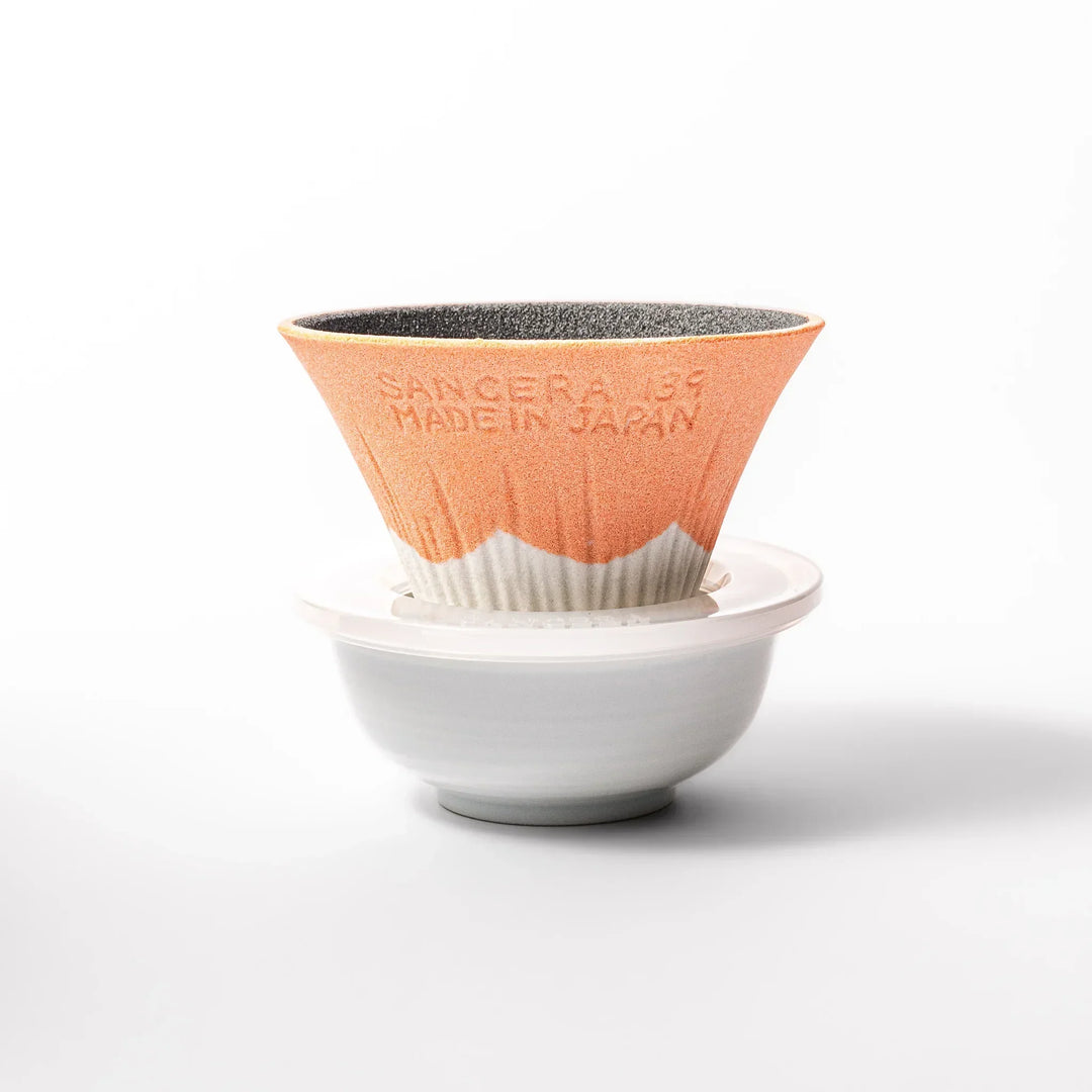 Orange Mount Fuji ceramic coffee filter with snowy peak handcrafted in Japan for modern pour over brewing.