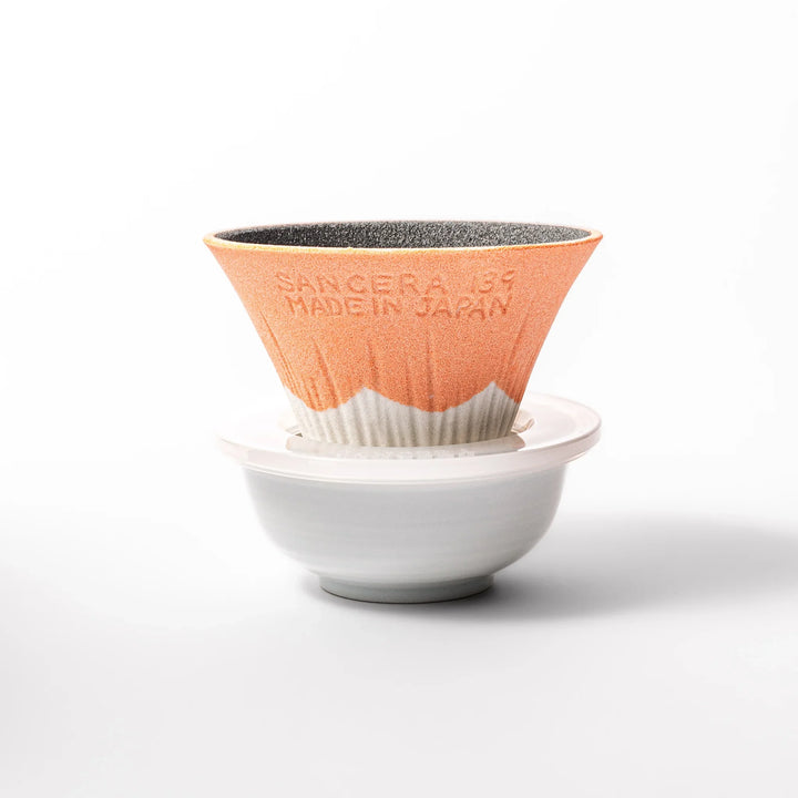 Orange Mount Fuji ceramic coffee filter with snowy peak handcrafted in Japan for modern pour over brewing.