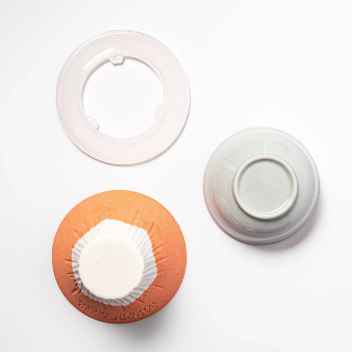 Orange Mount Fuji ceramic coffee filter with snowy peak handcrafted in Japan for modern pour over brewing.