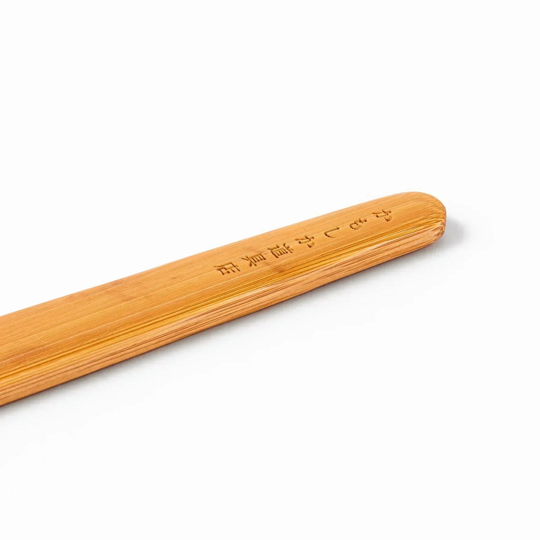 Bamboo natto stirring stick with a split-tip design and engraved Japanese text, ideal for mixing natto evenly and gently.