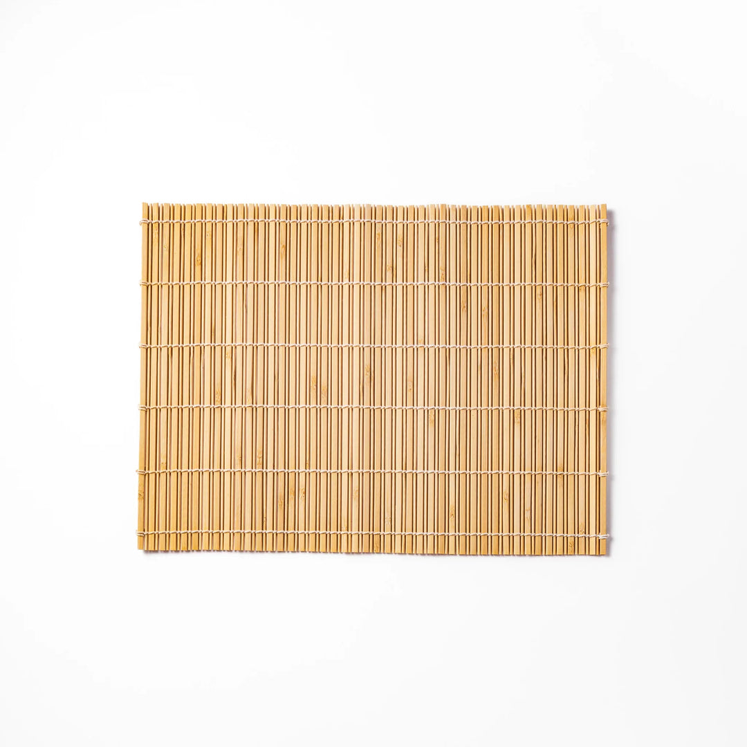 Natural bamboo table mat with vertical slats and white cord binding for earthy Japanese table settings.