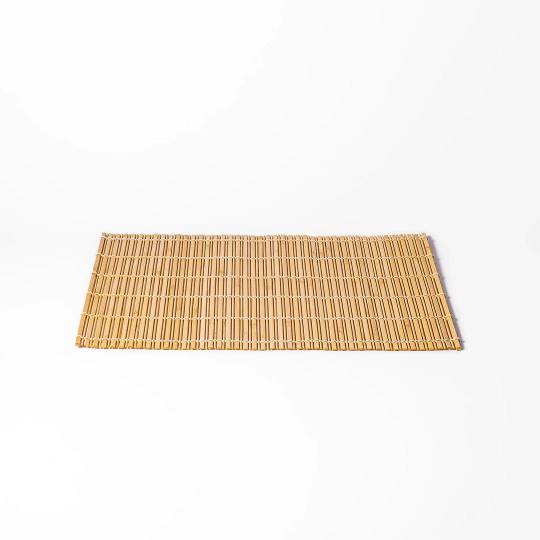 Natural bamboo table mat with vertical slats and white cord binding for earthy Japanese table settings.
