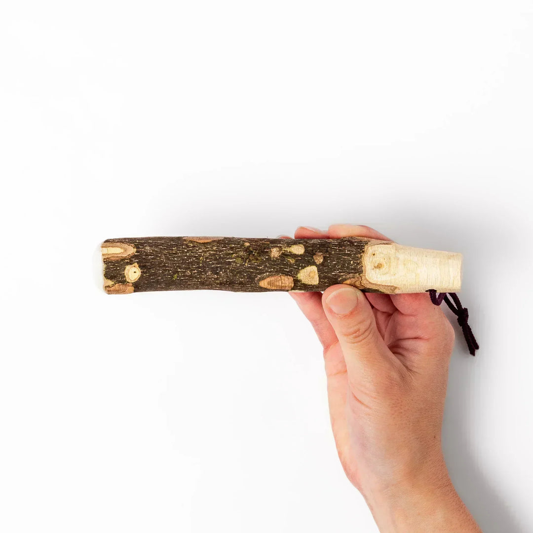 Natural sansho wood pestle featuring bark textures and a burgundy hanging cord, ideal for traditional Japanese grinding.