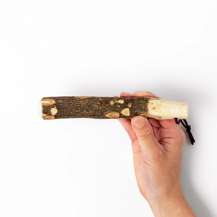 Natural sansho wood pestle featuring bark textures and a burgundy hanging cord, ideal for traditional Japanese grinding.