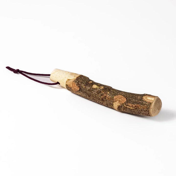 Natural sansho wood pestle featuring bark textures and a burgundy hanging cord, ideal for traditional Japanese grinding.
