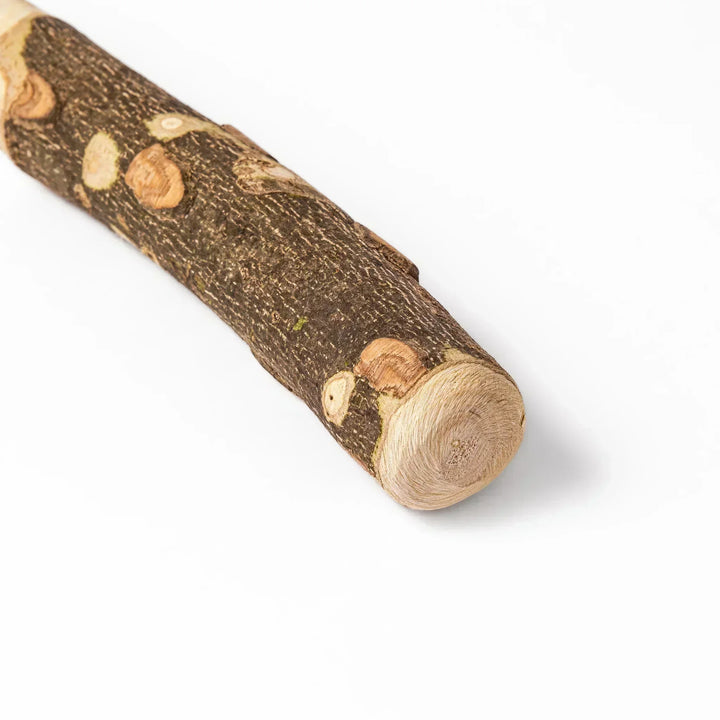 Natural sansho wood pestle featuring bark textures and a burgundy hanging cord, ideal for traditional Japanese grinding.