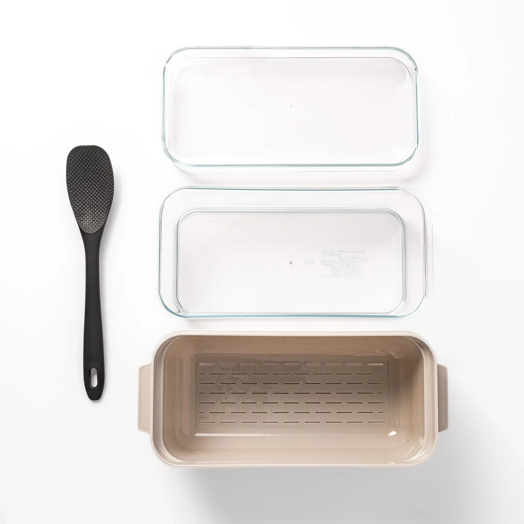 Japanese nukazuke fermentation box with clear lid and black rice paddle for home pickling and storage.