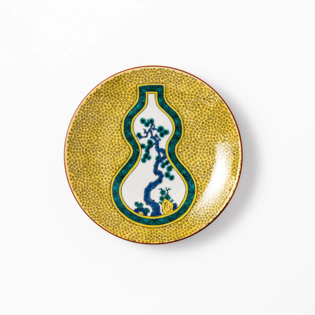Japanese porcelain dessert plate with yellow patterned background gourd center blue pine and green leaves.