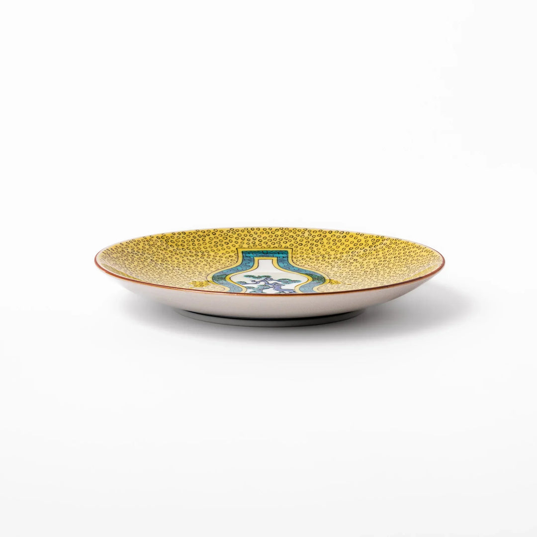 Japanese porcelain dessert plate with yellow patterned background gourd center blue pine and green leaves.