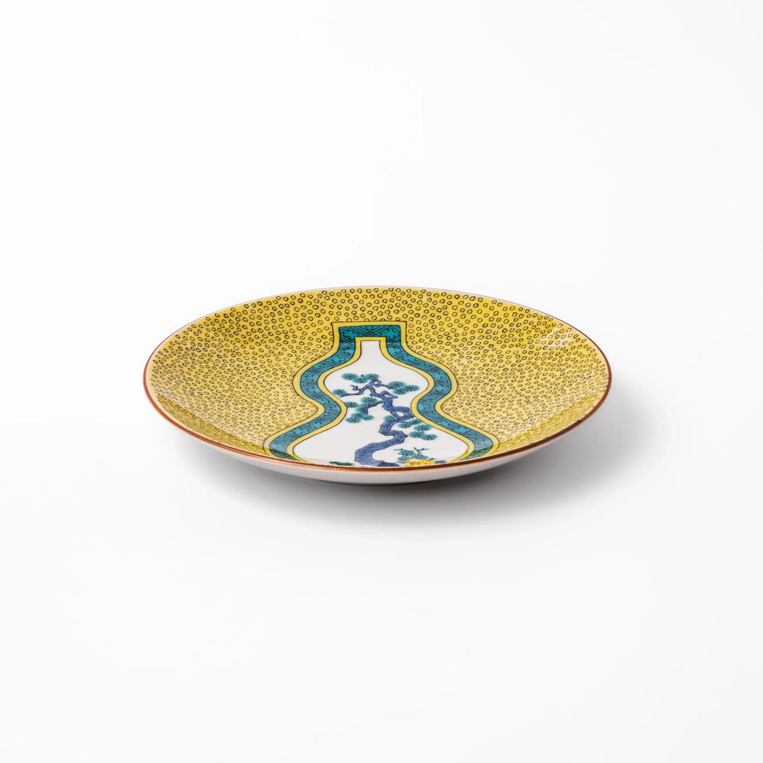 Japanese porcelain dessert plate with yellow patterned background gourd center blue pine and green leaves.