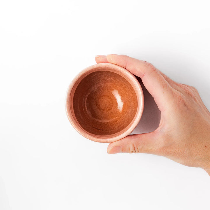 Pink crackle-glazed cup with gold accent and floral design, blending traditional charm and warmth.