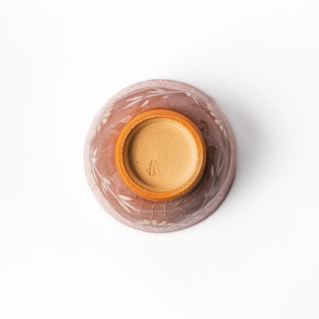 Pink crackle-glazed cup with gold accent and floral design, blending traditional charm and warmth.