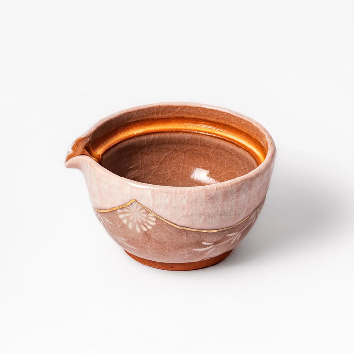 Turquoise crackle-glazed ceramic tea cup with floral patterns and earthy brown base, highlighting handcrafted beauty.