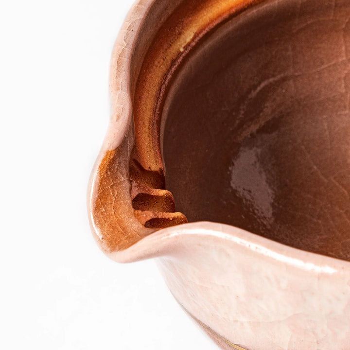 Turquoise crackle-glazed ceramic tea cup with floral patterns and earthy brown base, highlighting handcrafted beauty.