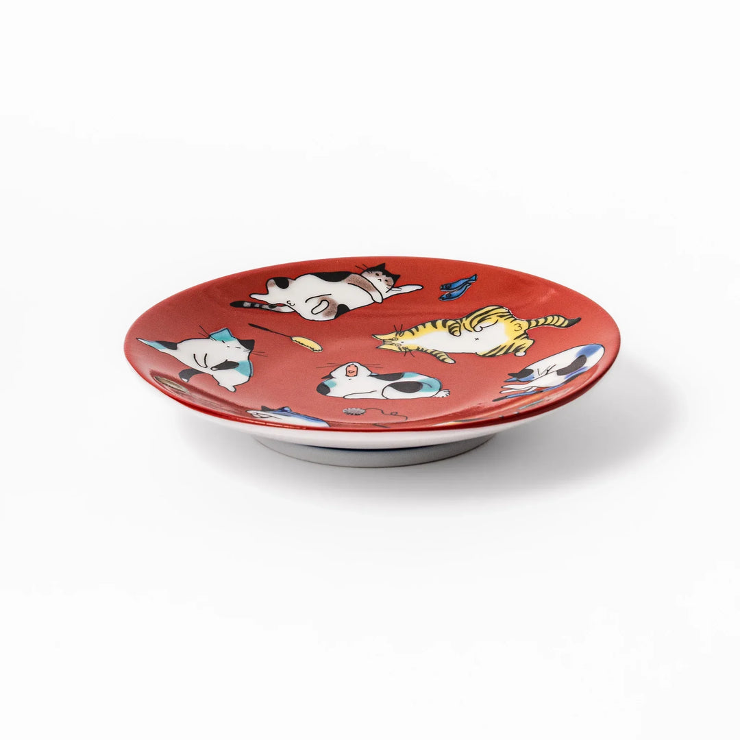 Red Japanese porcelain sauce dish featuring playful cat illustrations in various poses, perfect for soy sauce or dipping.