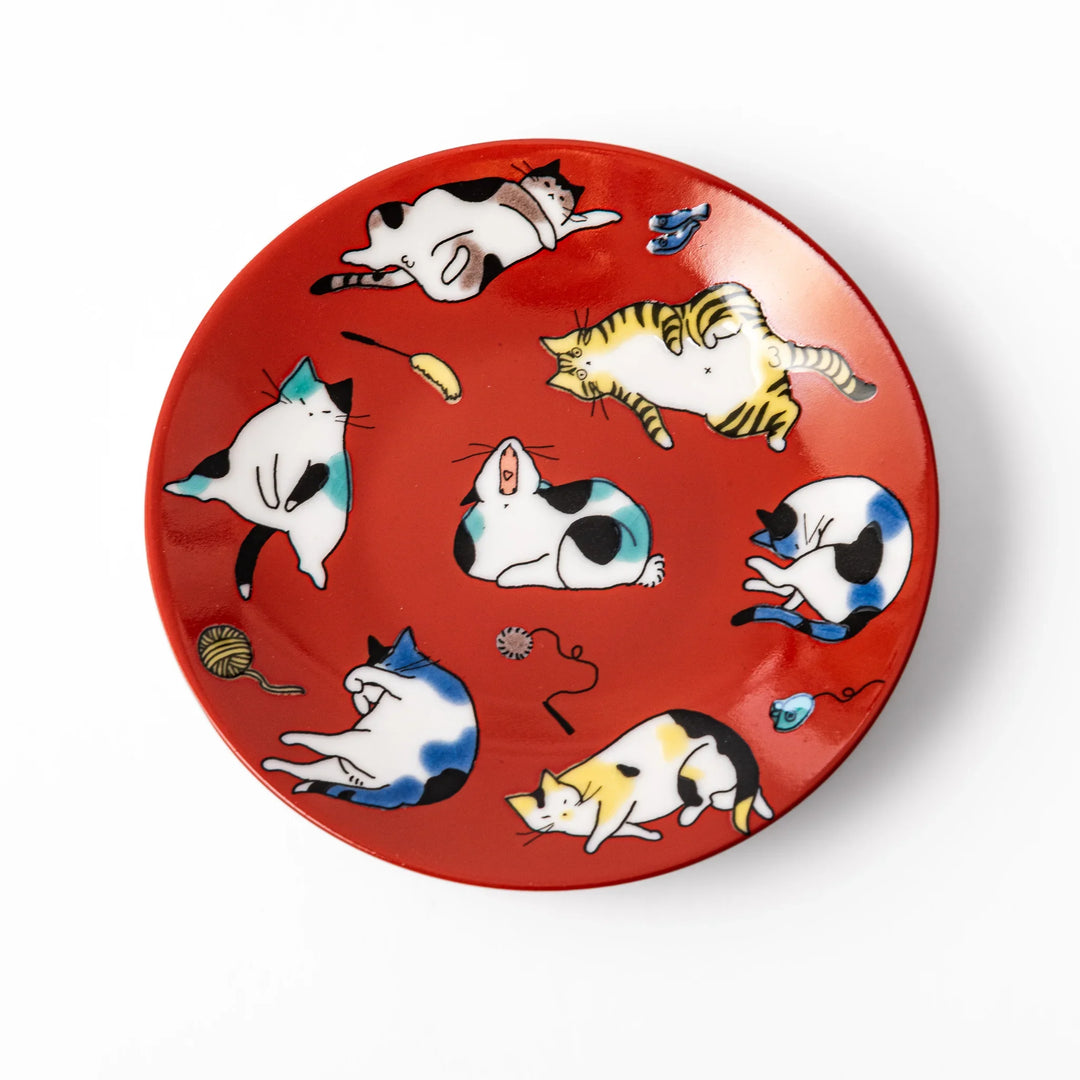 Red Japanese porcelain sauce dish featuring playful cat illustrations in various poses, perfect for soy sauce or dipping.