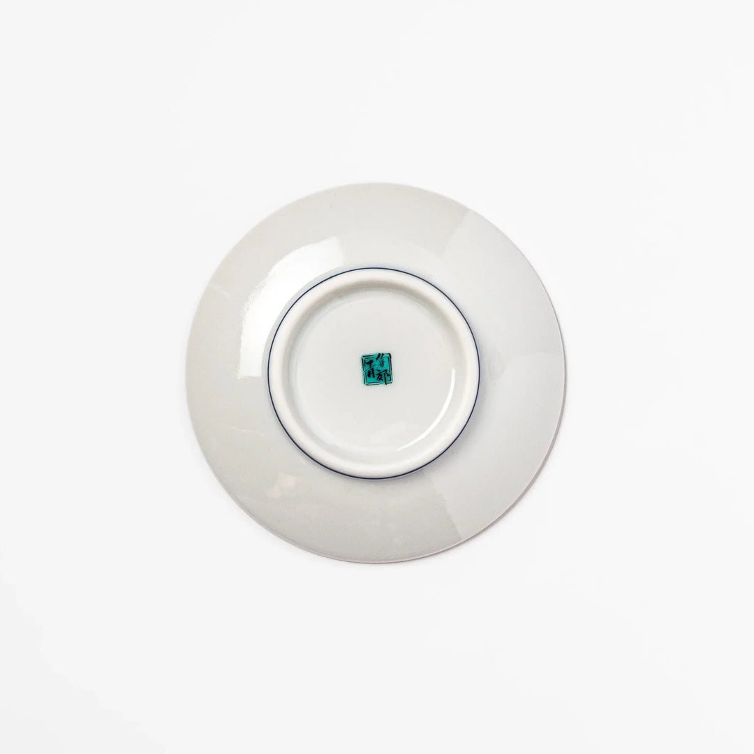 Round Japanese ceramic sauce dish with deep blue background featuring playful Shiba Inu dogs and paw prints.