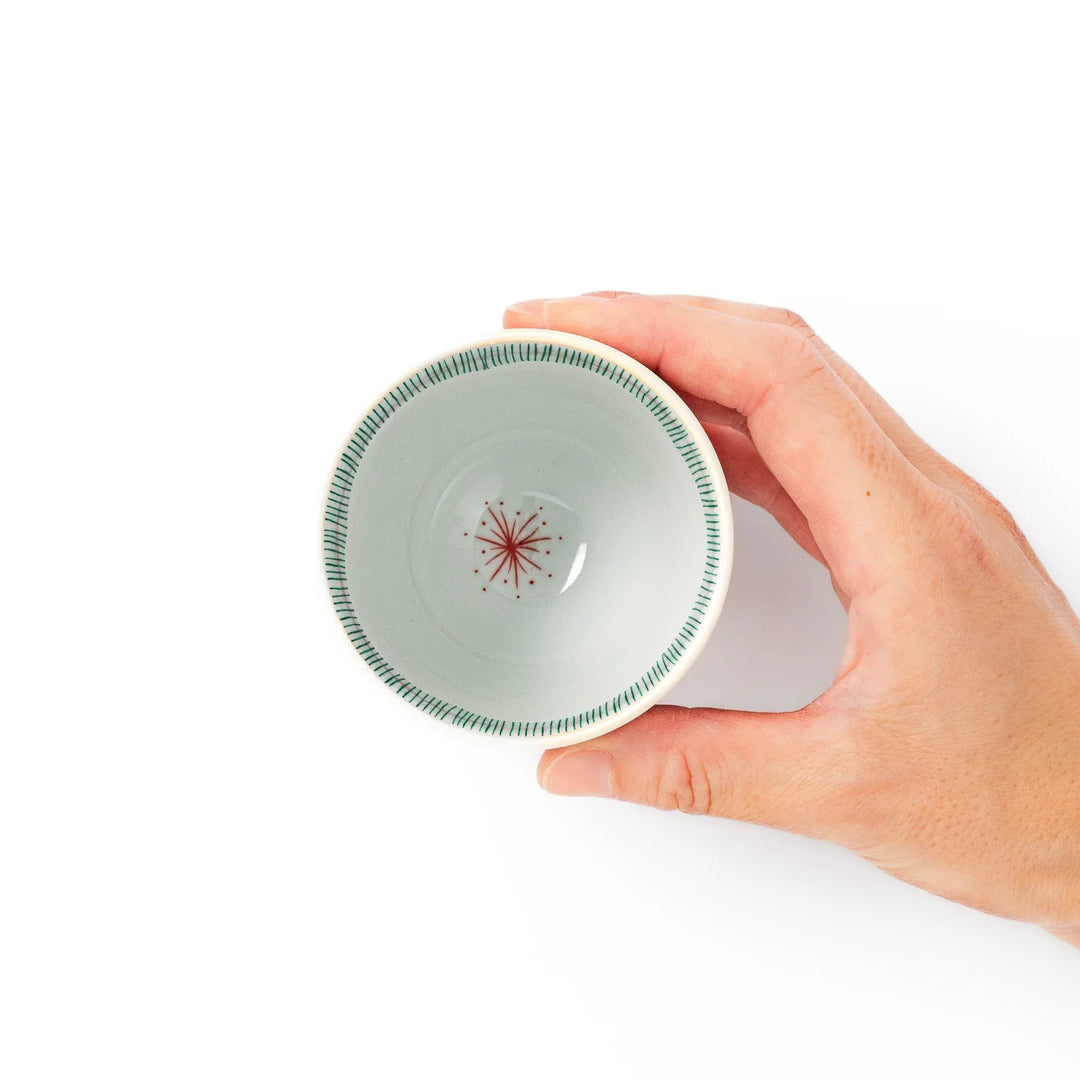 Japanese ceramic tea cup with plum petal stripe design blending modern simplicity with traditional elegance.