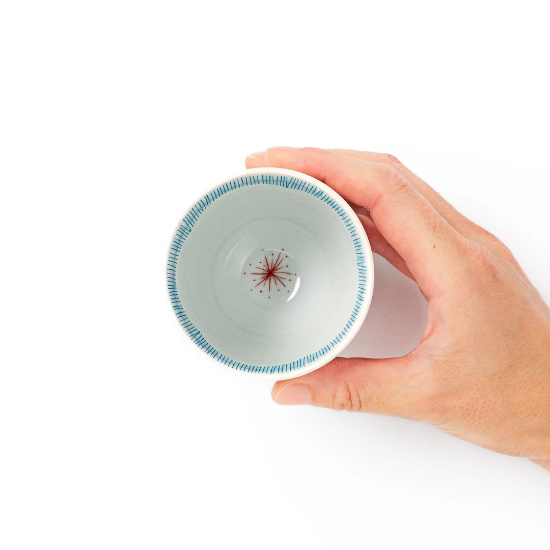 Japanese ceramic tea cup with plum petal stripe design in blue, showcasing minimalist elegance and traditional Japanese craft