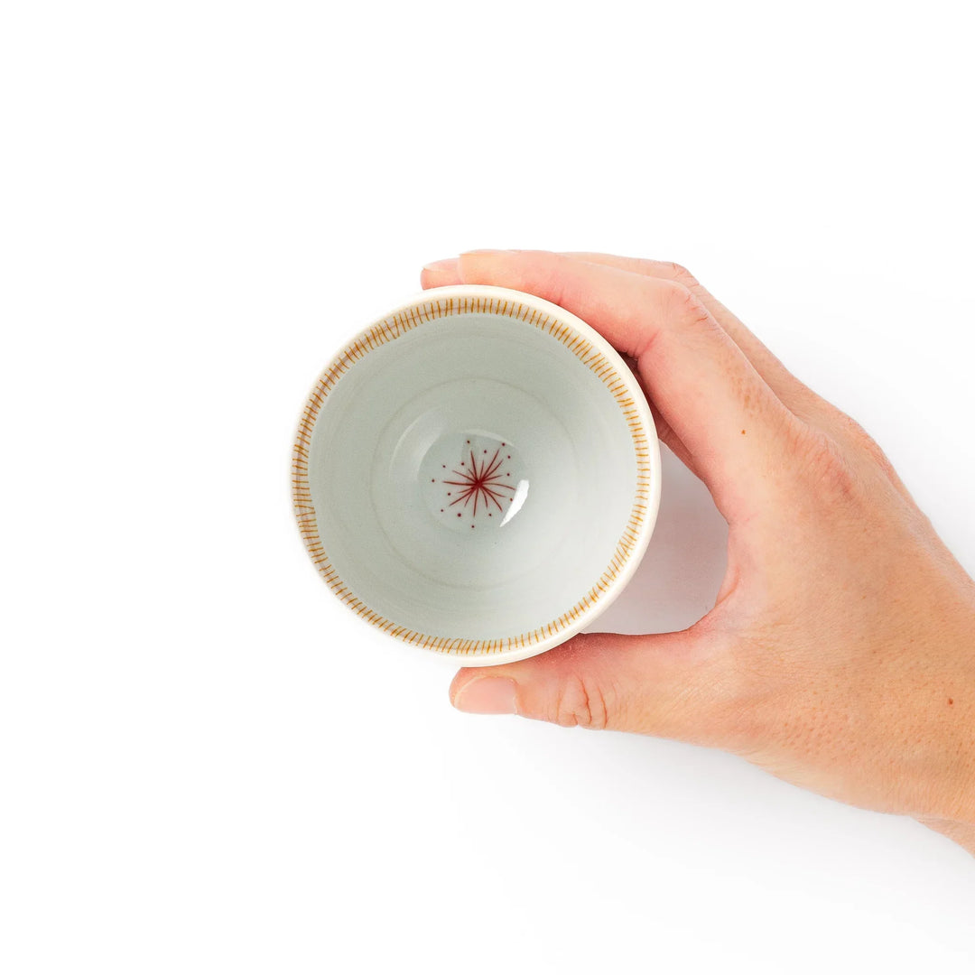 Japanese ceramic tea cup with plum petal stripe design in orange, combining modern minimalism and traditional Japanese style