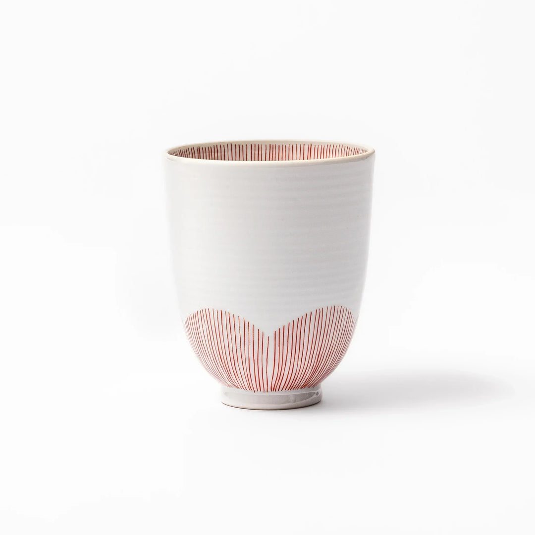 Japanese ceramic tea cup with plum petal stripe design in red, combining traditional elegance and modern simplicity