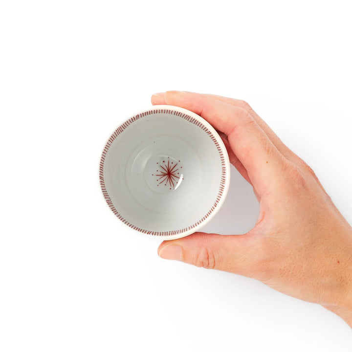 Japanese ceramic tea cup with plum petal stripe design in red, combining traditional elegance and modern simplicity